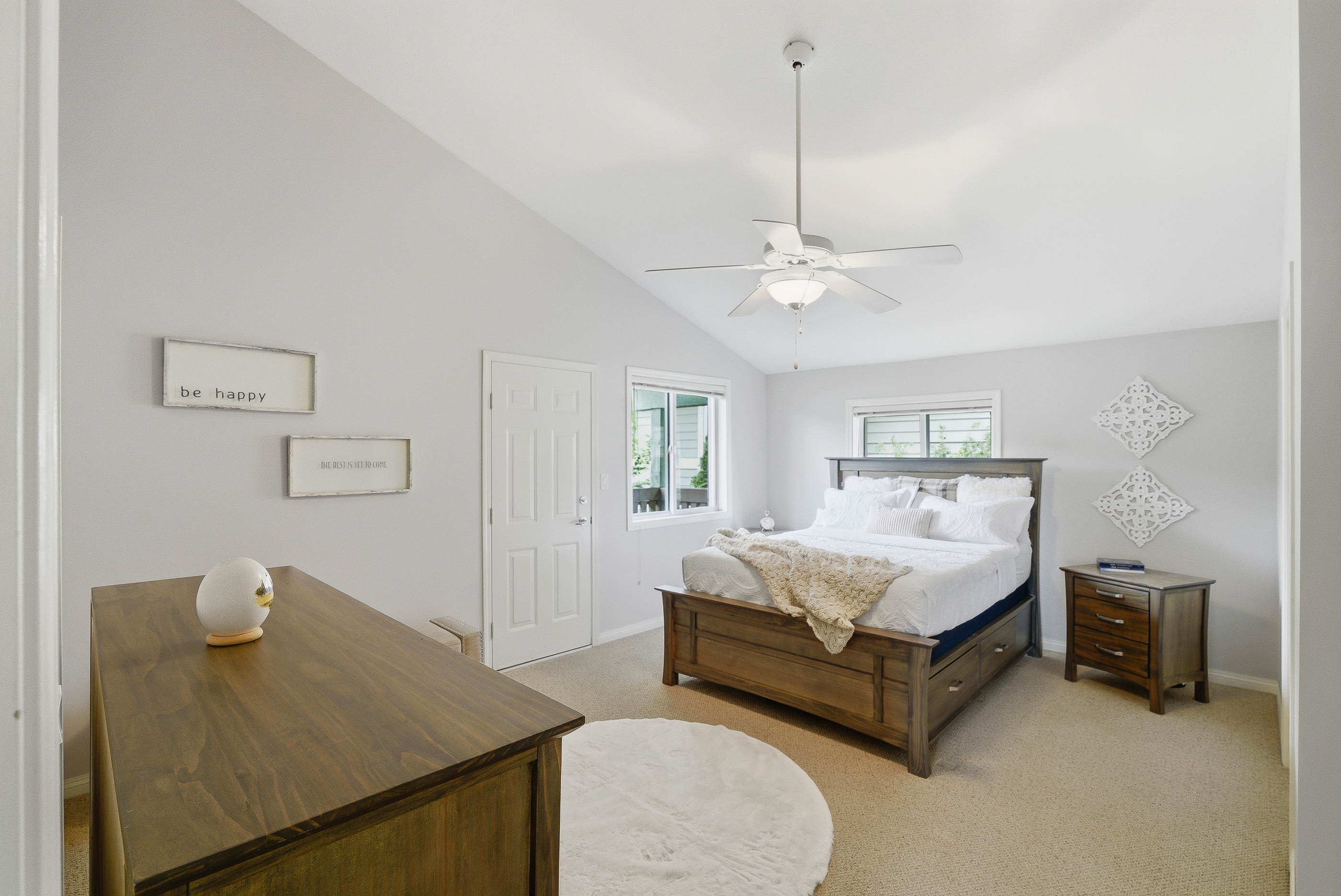 Second upstairs bedroom with vaulted ceiling, queen bed and bright windows facing the back yard
