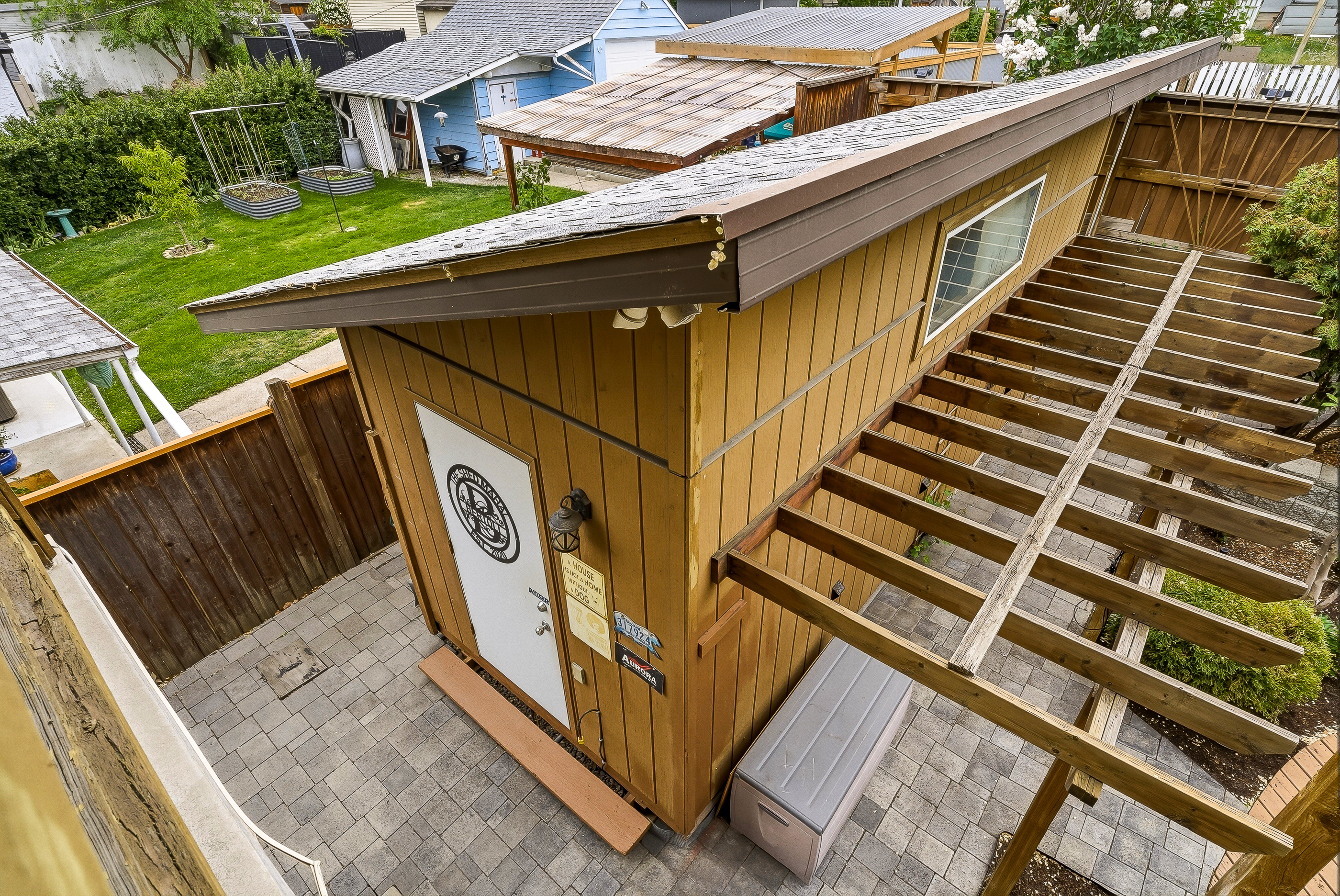 Heated, insulated workshop steps from the back door at 1127 Columbia St — steel door, mezzanine stairs and adjacent paver pad
