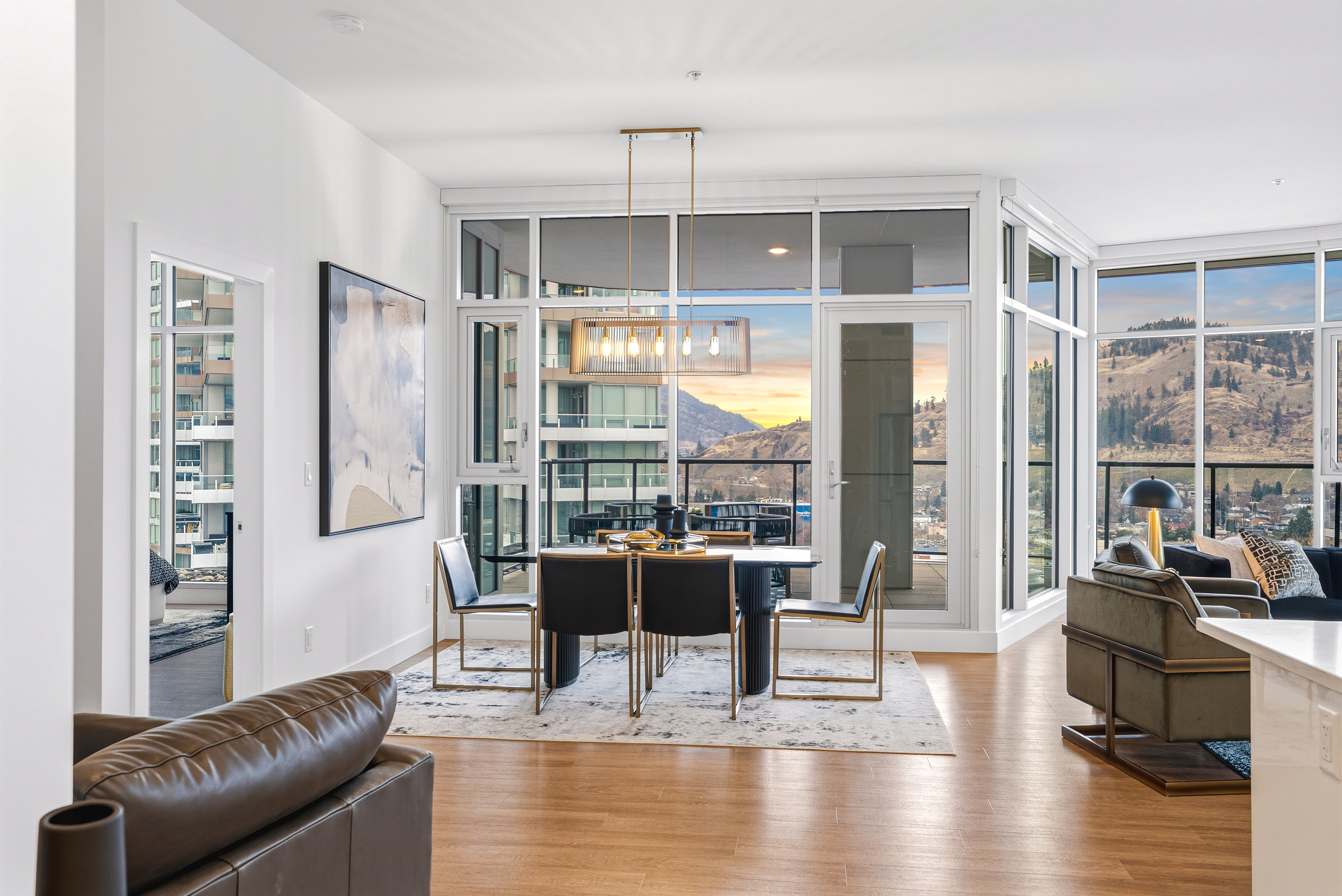 Dining room with chandelier opening onto the curved balcony at sunset