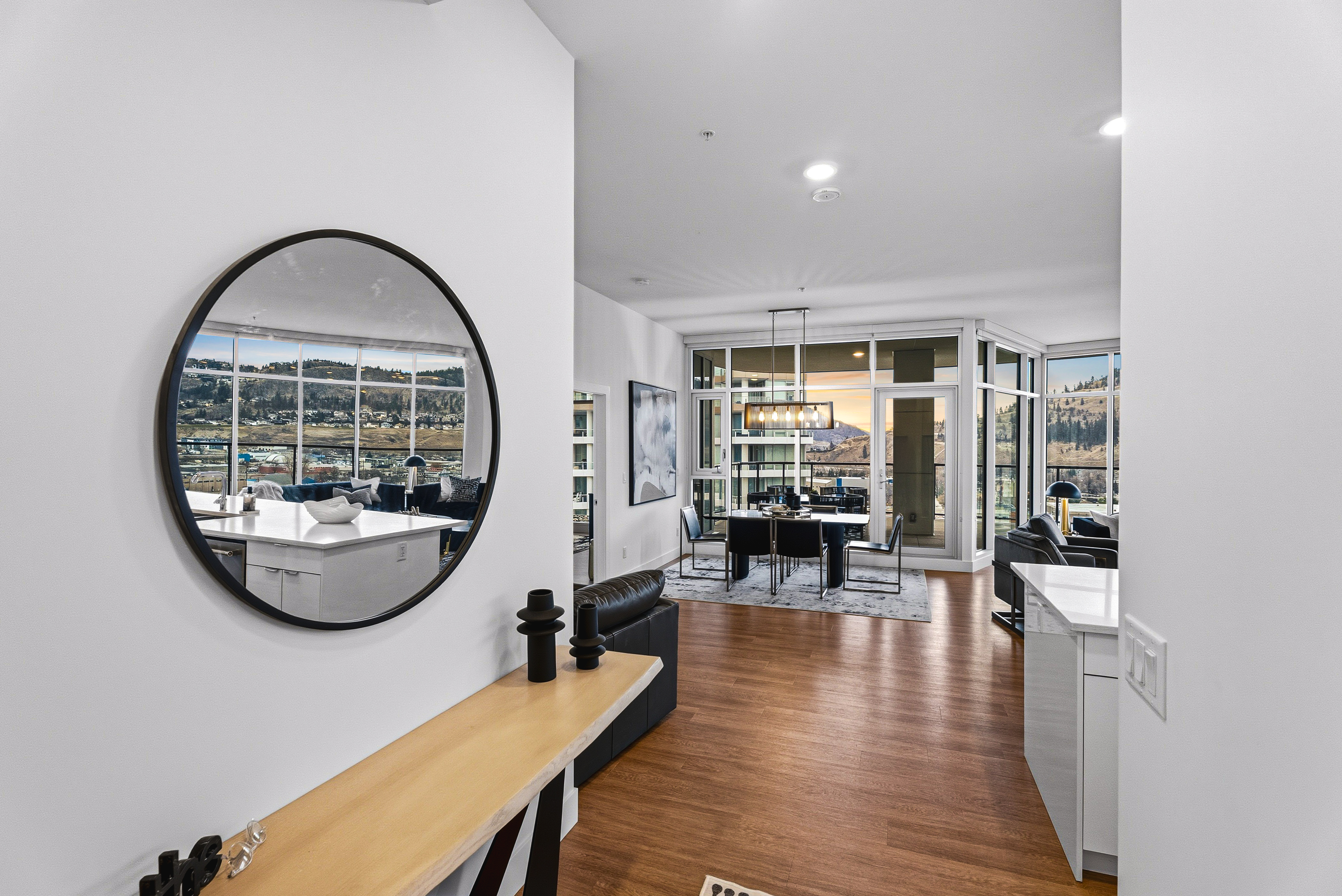 Entry foyer with round mirror reflecting the lake view and dining area