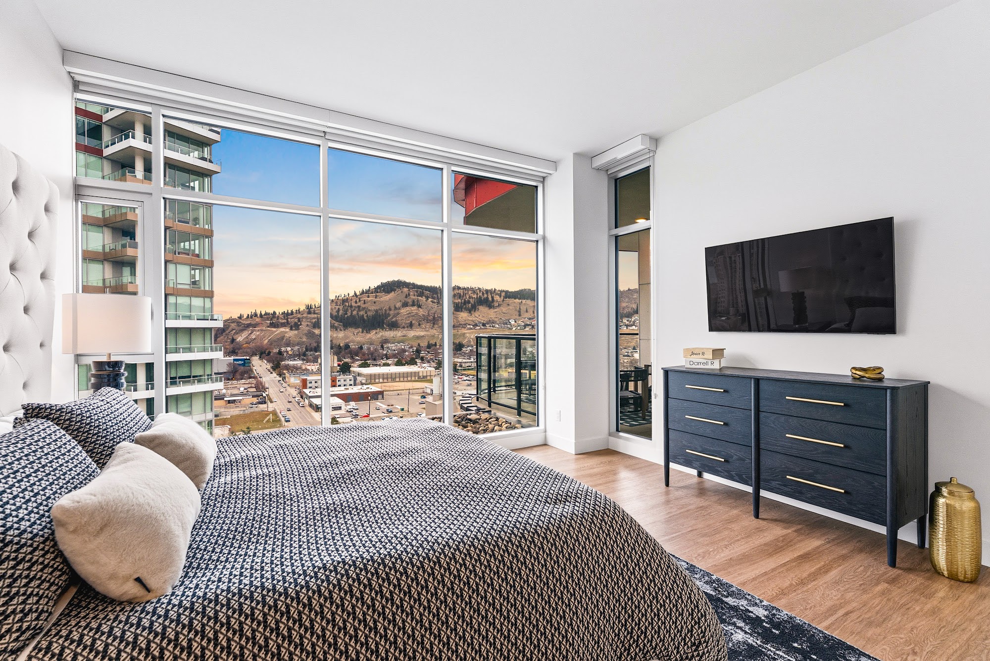 Second bedroom with king bed, built-in TV wall, and the Knox Mountain view out the window