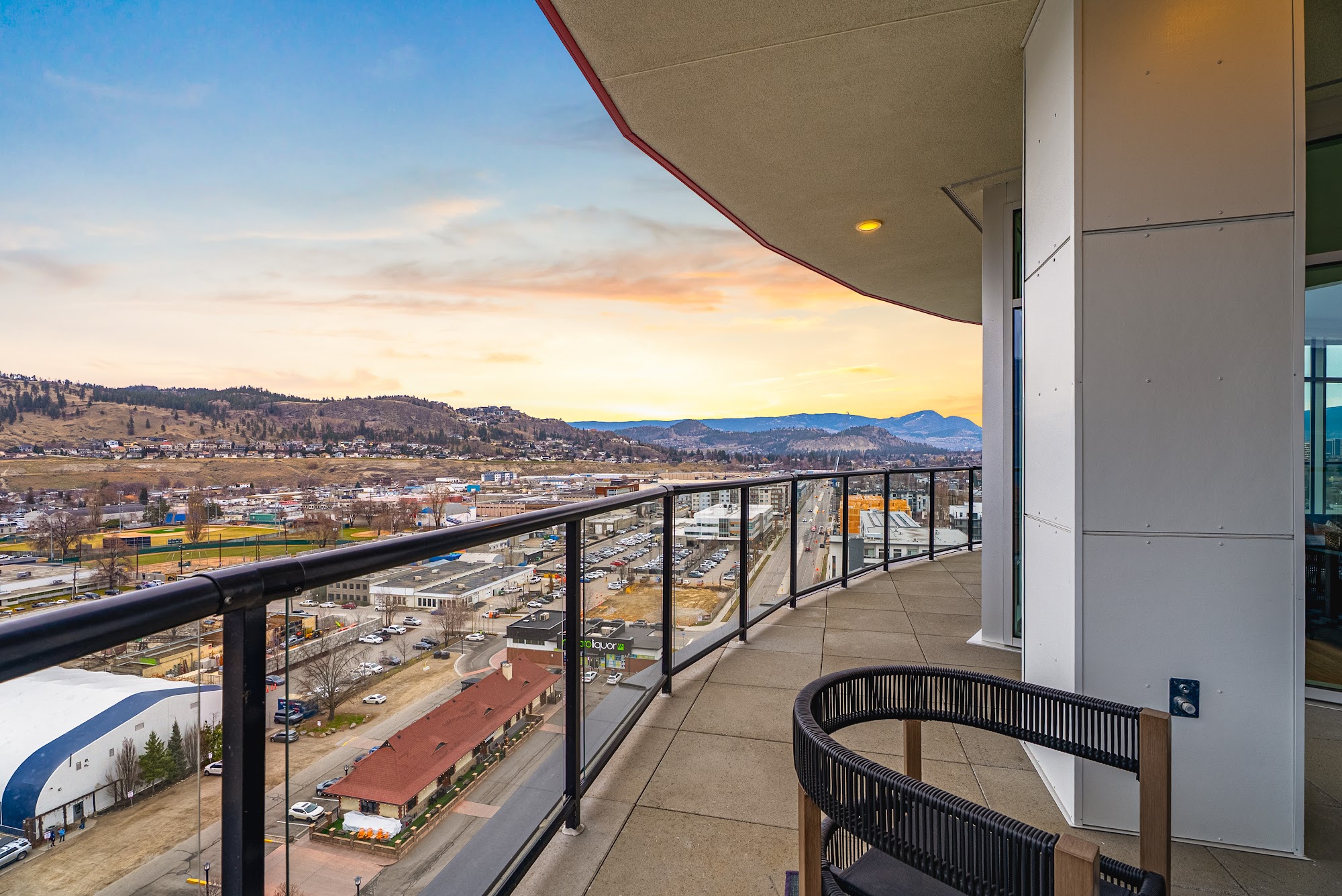 Wrap-around deck at sunset with downtown Kelowna and the lake straight ahead