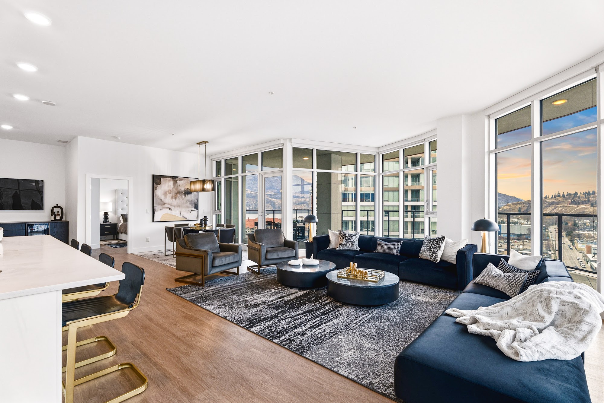 Dining room set against the corner glass with downtown and Knox Mountain in the view