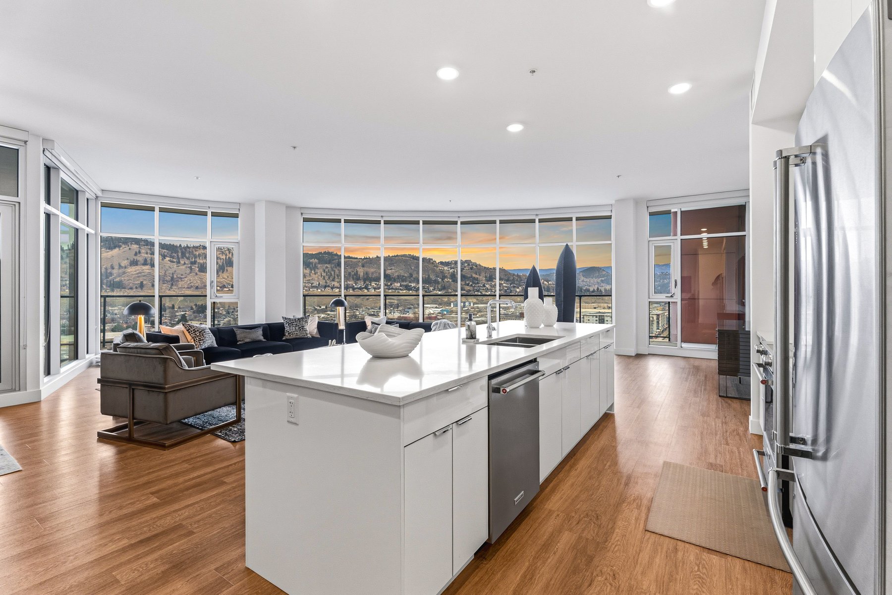 Open kitchen and living area with floor-to-ceiling windows looking north