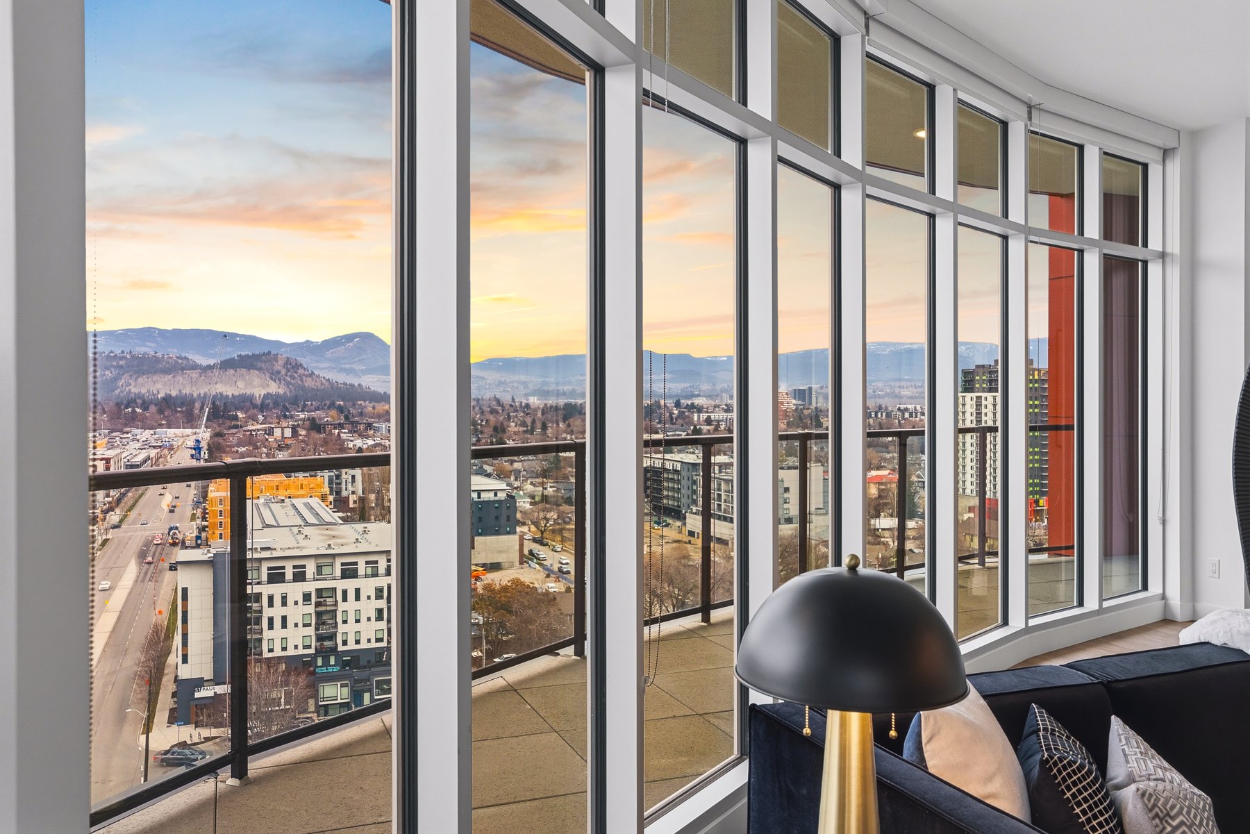 Corner of the living room with view of the wrap-around deck and city