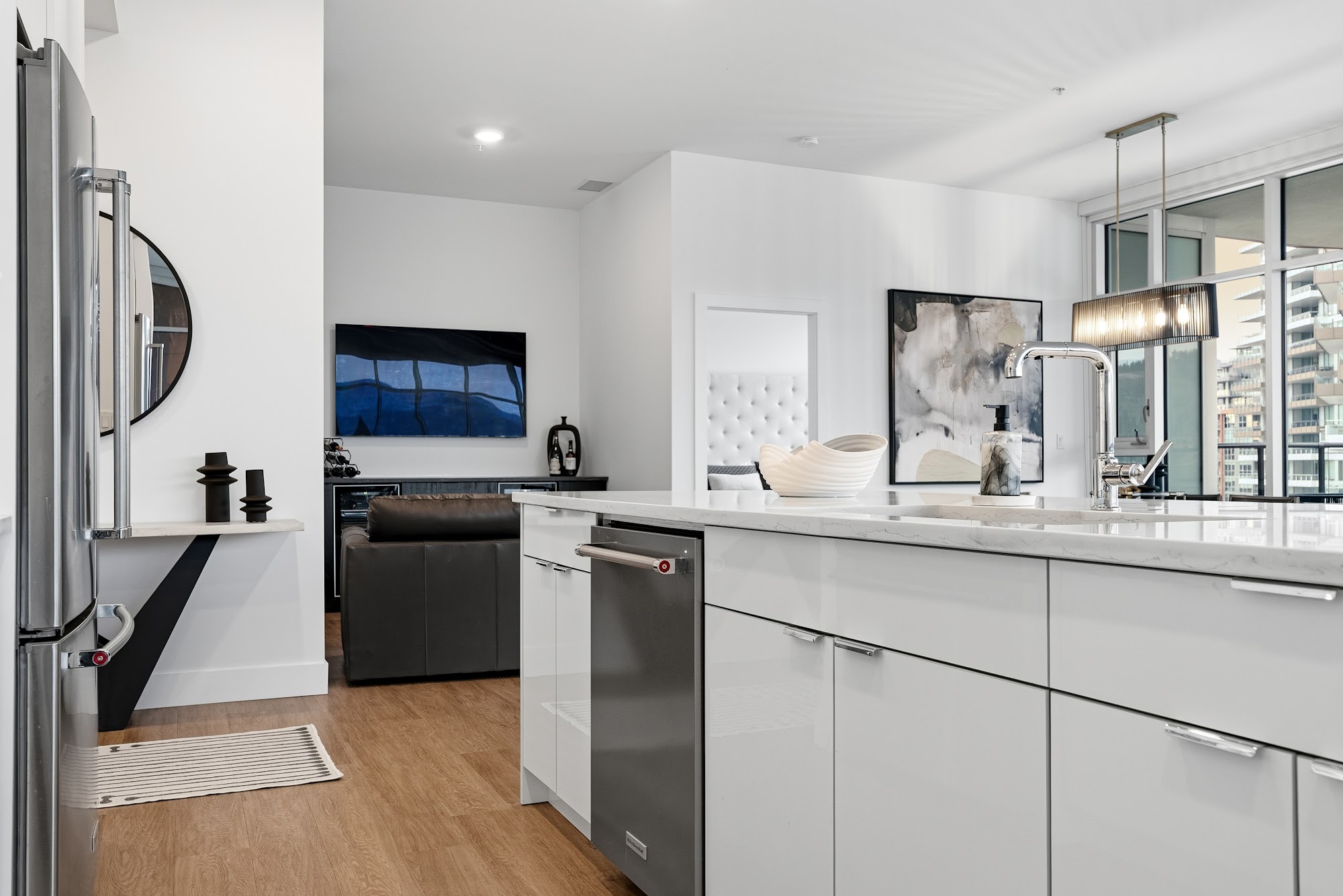 Kitchen island detail with quartz waterfall edge and integrated stainless appliances