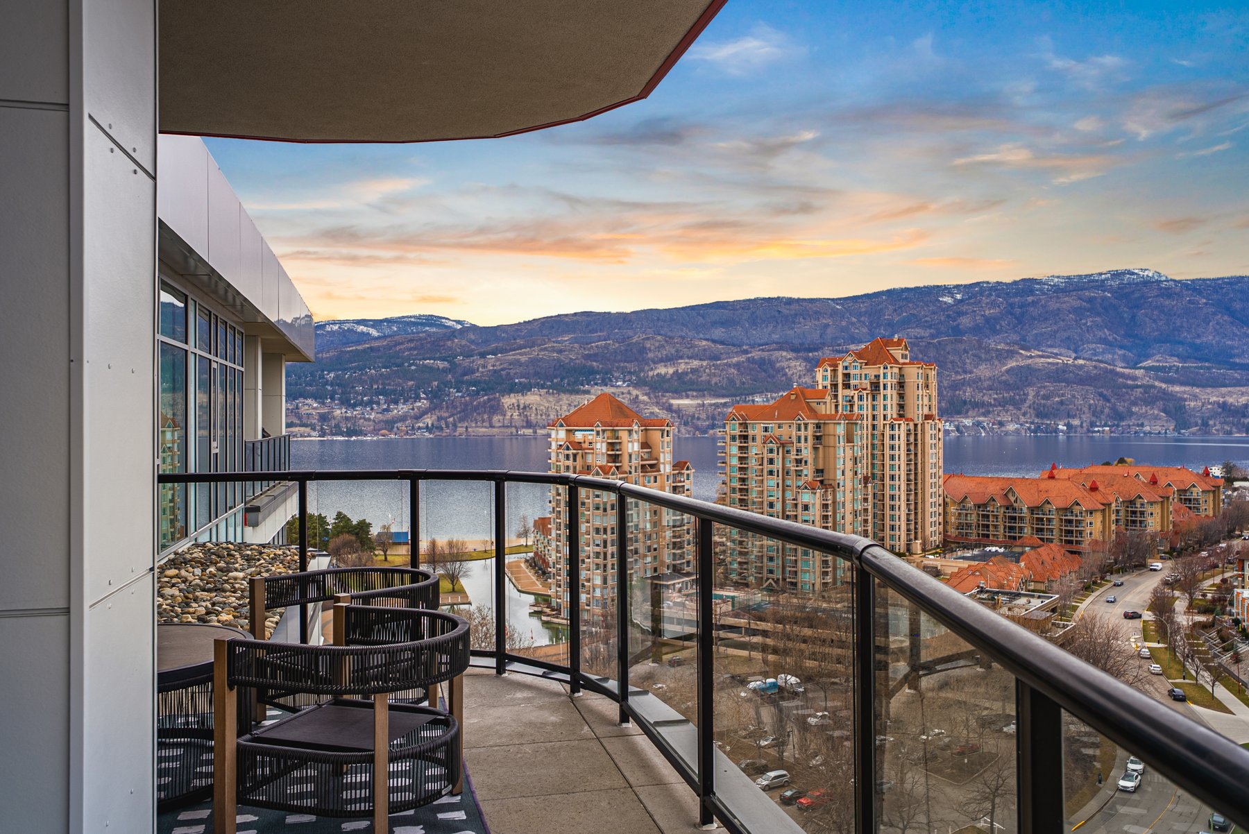 Sunset over Okanagan Lake and the West Kelowna hills, seen from the wrap-around deck off the corner penthouse