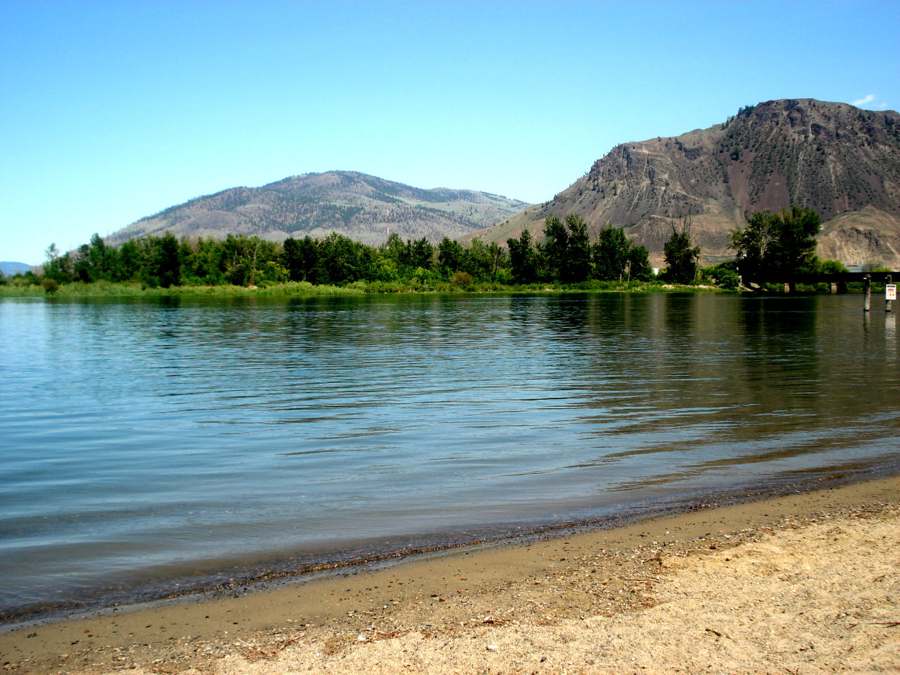 Riverside Park beach with the Thompson River and hills behind