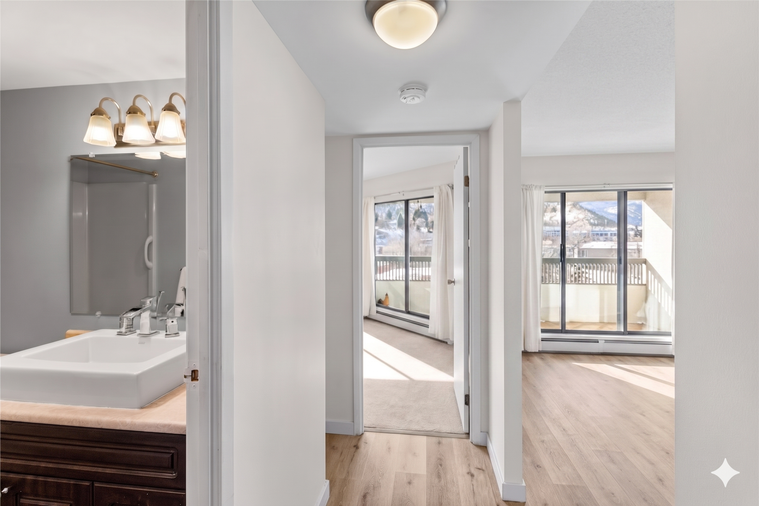 Bathroom doorway and hallway with linen cabinet